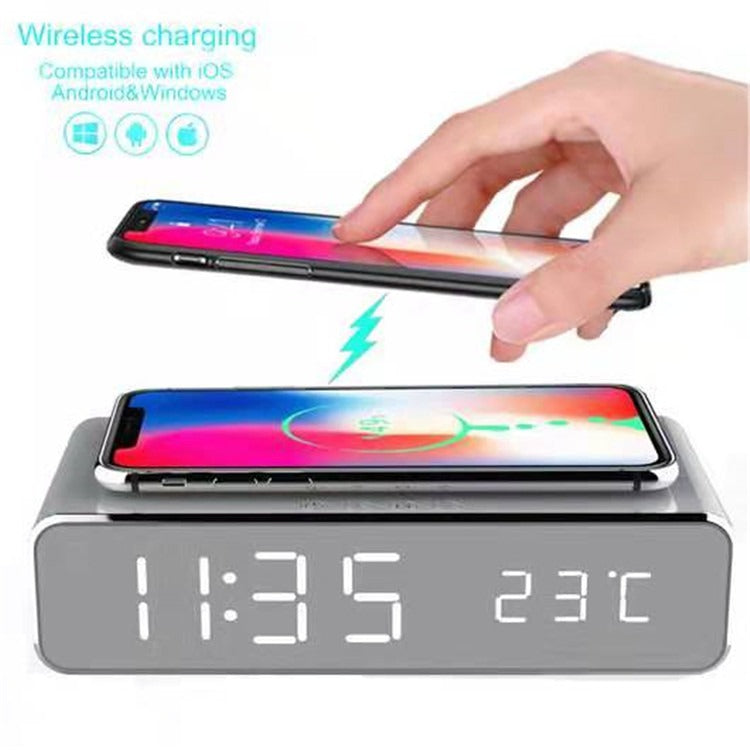 Wireless charging desktop clock with mirror LED display showing time and 23°C, phone charging on top.