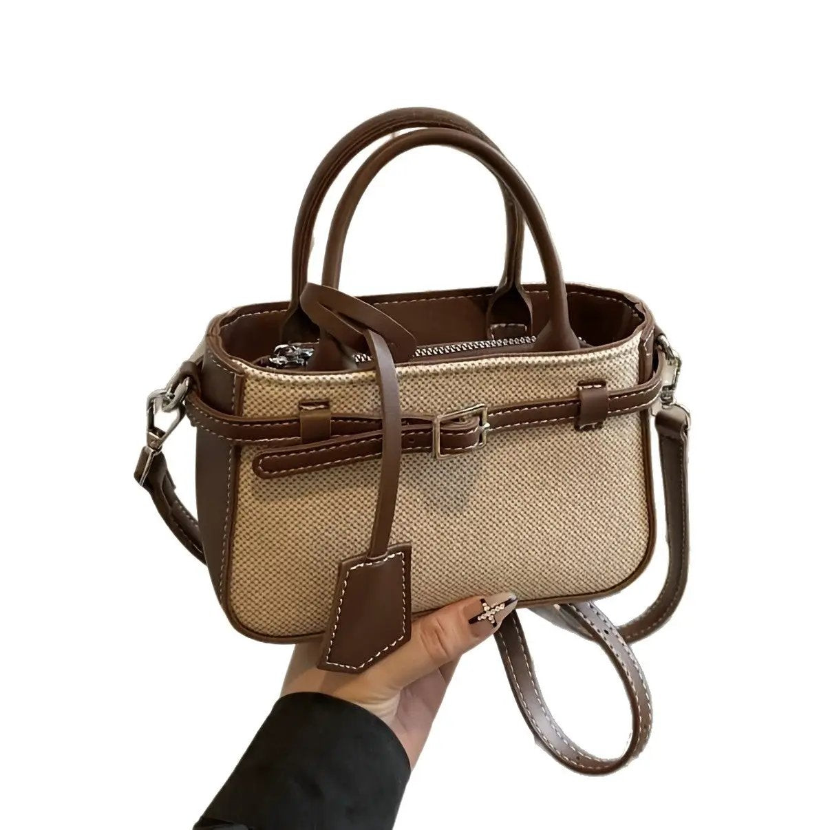 Commuter-friendly crossbody tote bag with brown leather trim, beige canvas, top handles and detachable shoulder strap