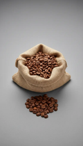 Roasted coffee beans in a burlap bag with spilled beans nearby