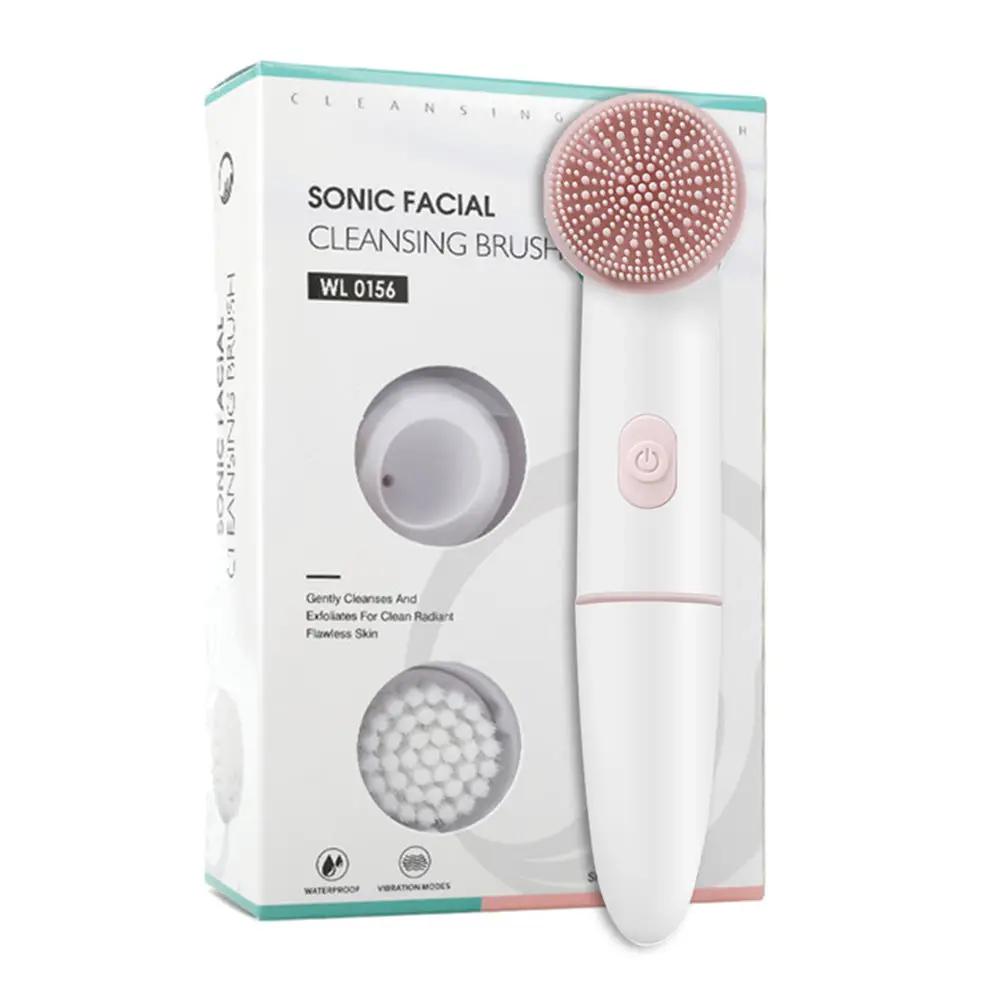 Sonic facial cleansing brush with white handle and pink silicone head; includes two replaceable heads