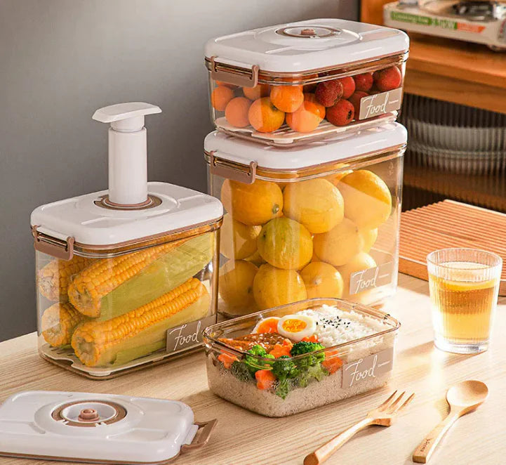 Anti Spier Food Vacuum Storage Box set; clear stackable boxes with white lids, holding corn, citrus, and grain salad.