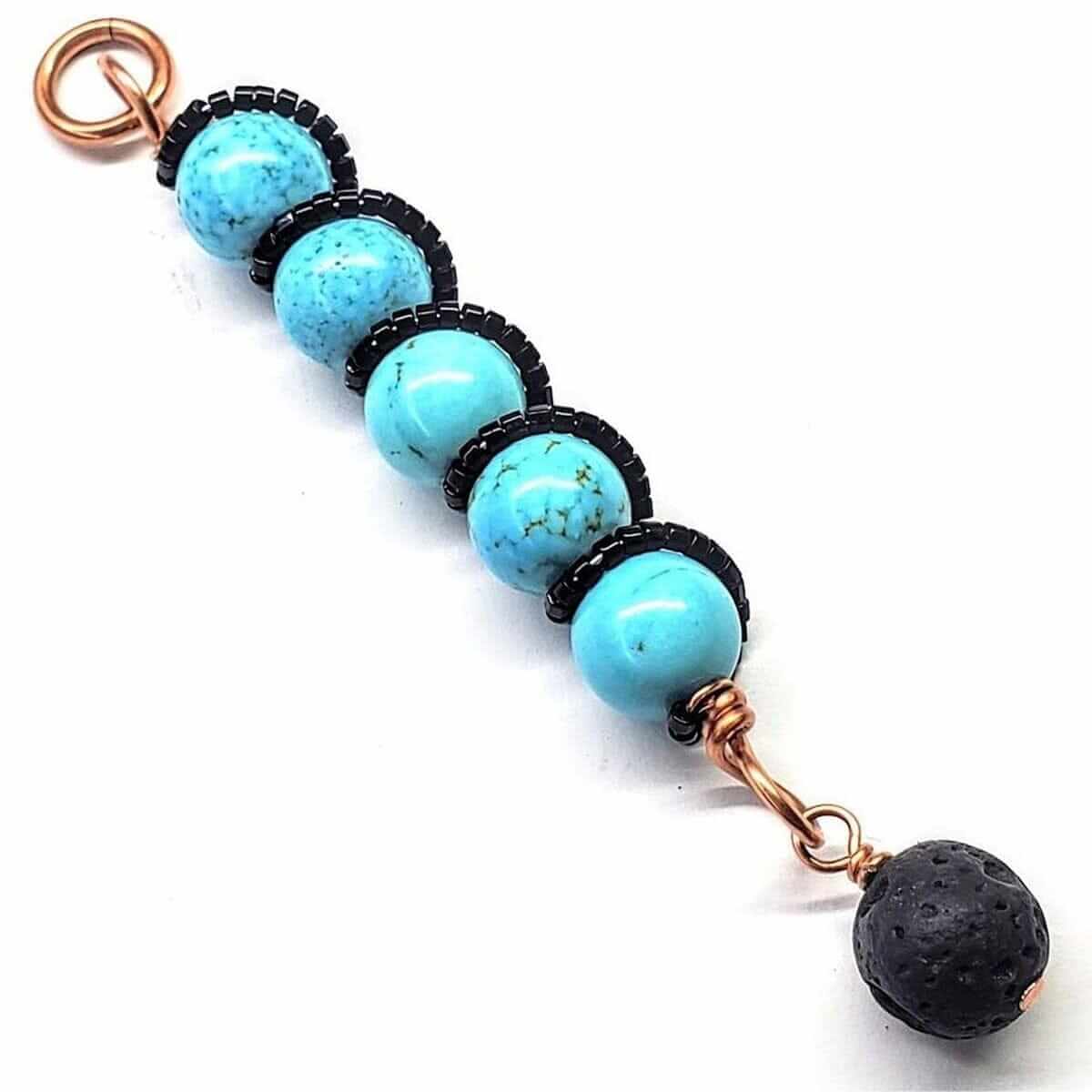 Copper turquoise bead necklace with five turquoise stones, black spacer beads, and lava rock pendant