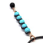 Copper turquoise pendant necklace with lava rock charm, turquoise beads and black coil spacers by Alexa Martha Designs