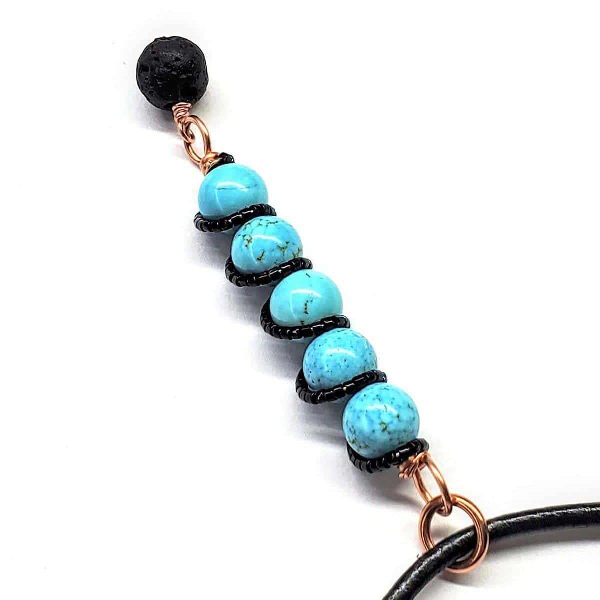 Copper turquoise pendant necklace with lava rock charm, turquoise beads and black coil spacers by Alexa Martha Designs