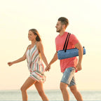 Quick-open beach tent blue carry bag carried by a couple walking on the beach