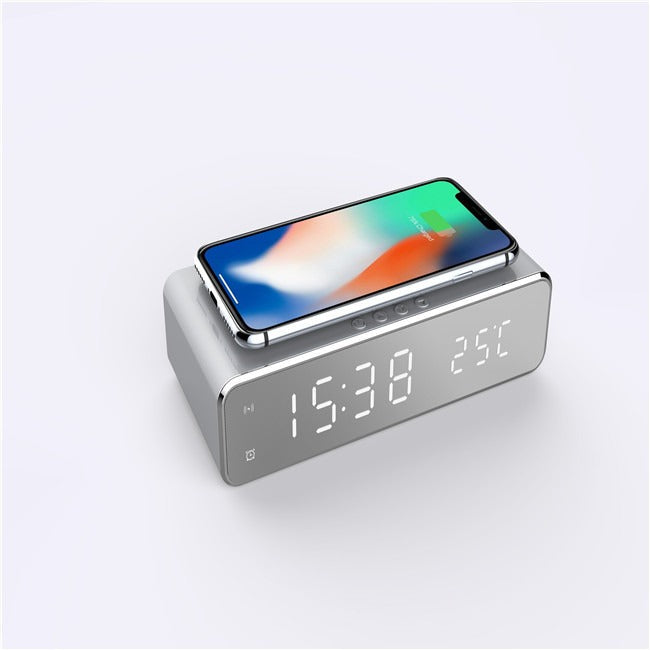 Silver desktop clock with mirror LED display and wireless charging pad for phones, temperature display