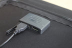 ACOPOWER 100W foldable solar panel in use outdoors.