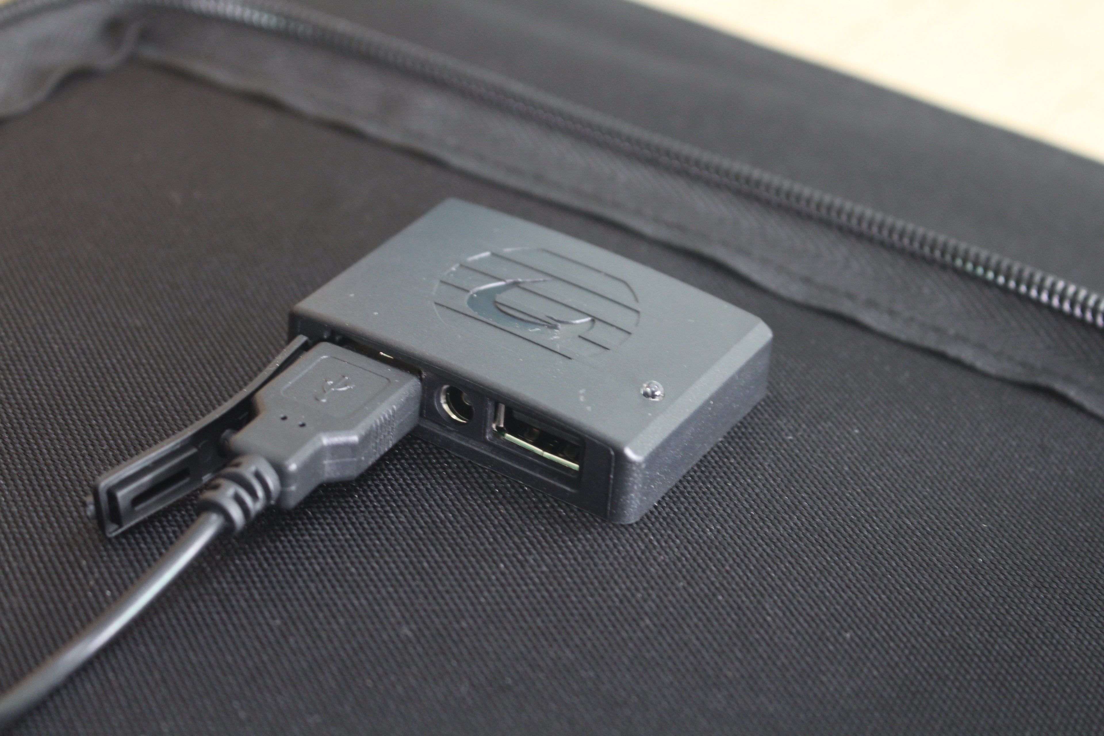 ACOPOWER 100W foldable solar panel in use outdoors.