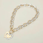 Hammered layered heart pendant necklace by Madeline Love on a gold and silver chunky chain