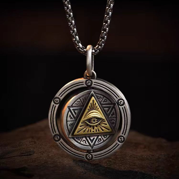 God's Eye Rotatable Pendant by nowadaysfashion; silver circular pendant with gold triangle eye motif on chain