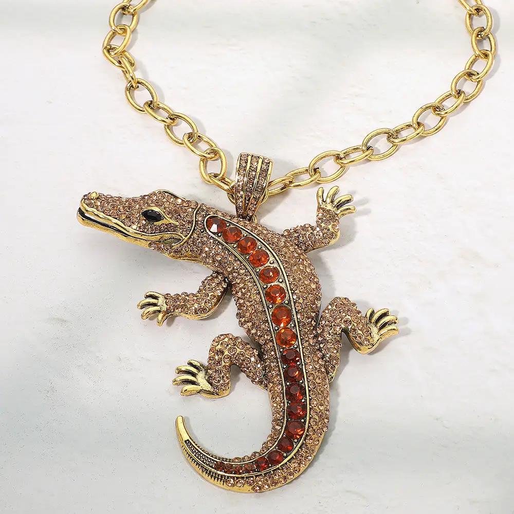 Bold Bling Studded Alligator Pendant Necklace on a chunky gold chain with red rhinestones