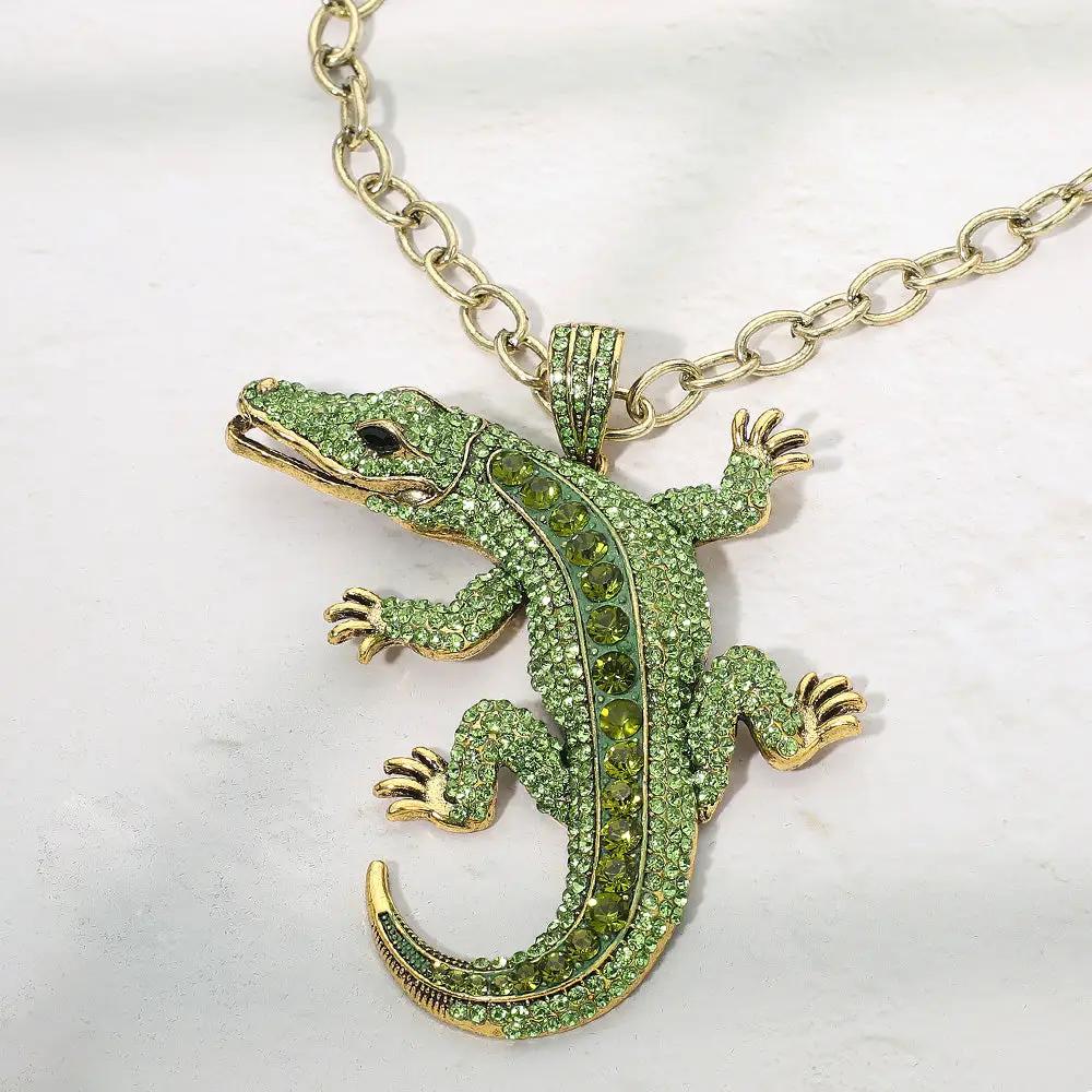 Bold Bling Alligator Pendant Necklace by Madeline Love; gold-tone crocodile with green crystals on a chunky chain