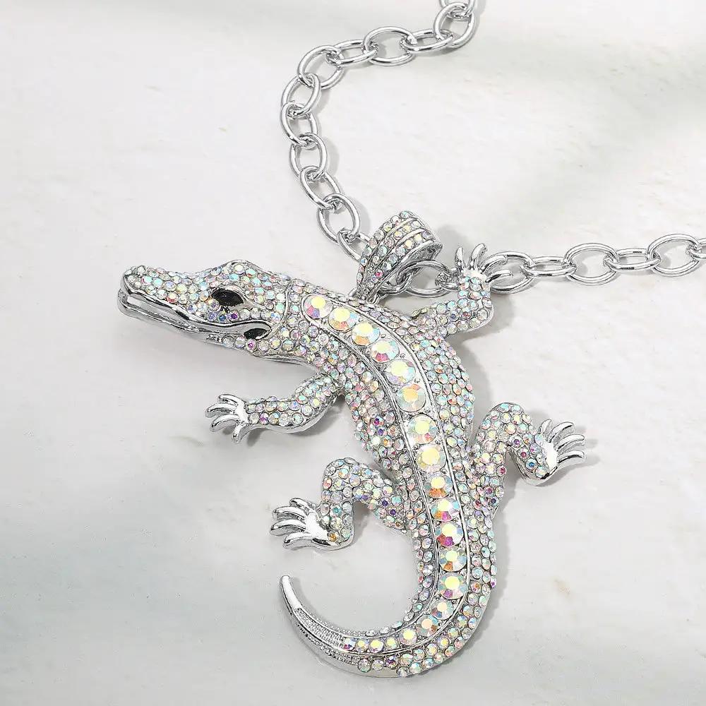 Necklace: Madeline Love rhinestone-studded alligator pendant on a chunky silver chain, bold statement piece