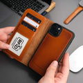 Tan TORONATA Casper leather MagSafe wallet case for iPhone 16 Plus.