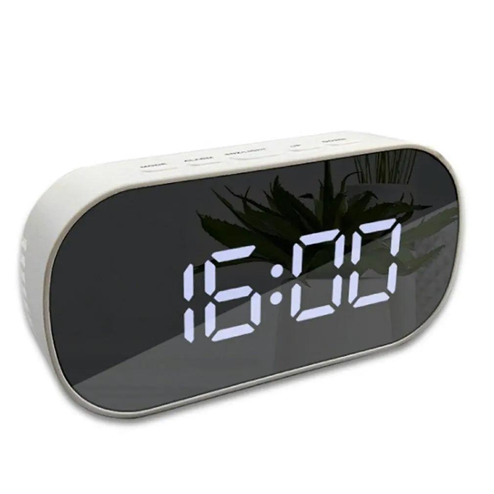 Digital alarm clock with large LED display on curved mirror surface; white body for modern bedside or desk decor.