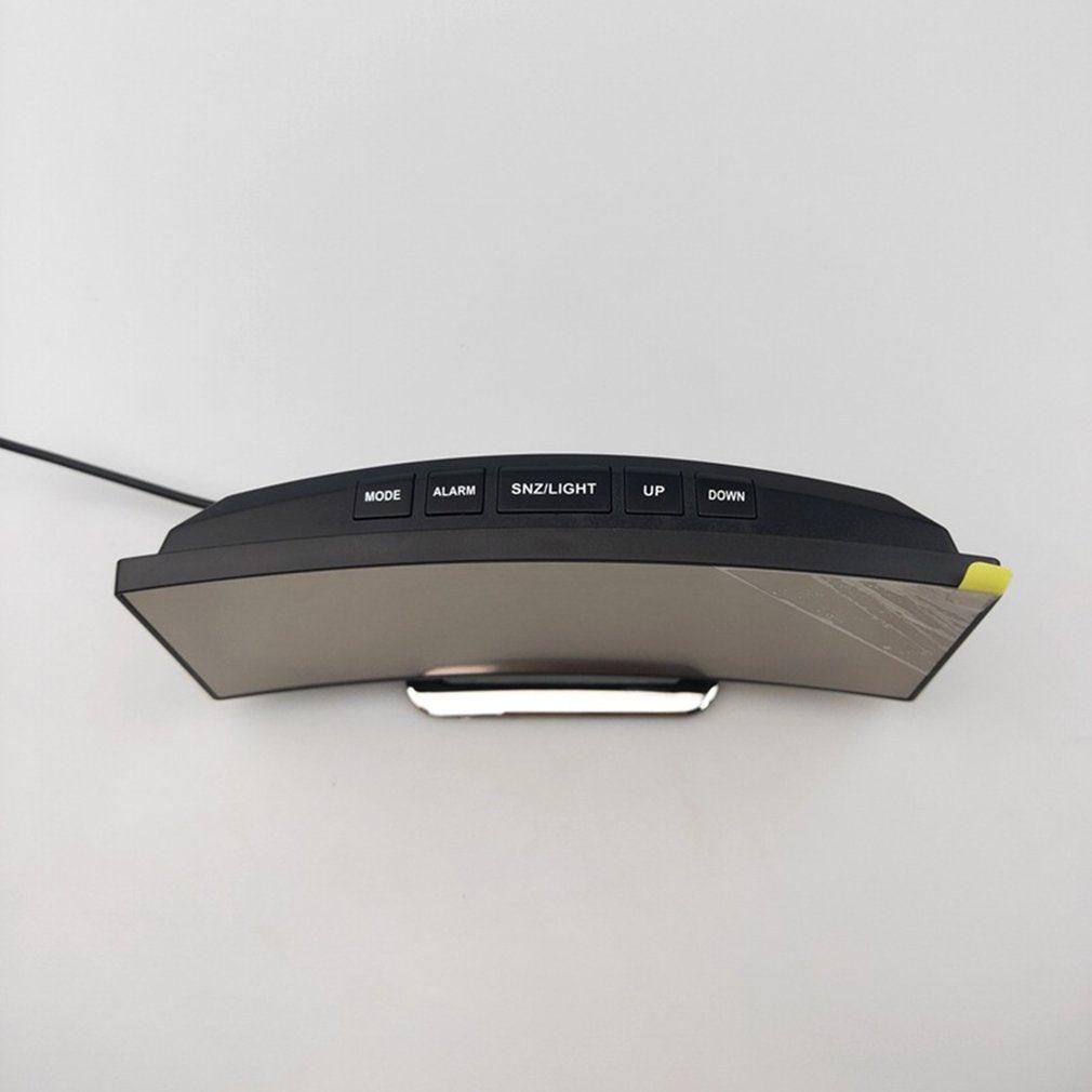Digital alarm clock with curved mirror surface and large LED display; black desktop clock with 5-button control