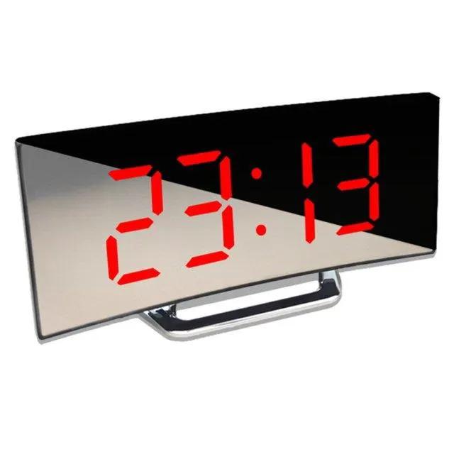 Digital alarm clock with large red LED display on a curved mirrored panel and chrome stand.