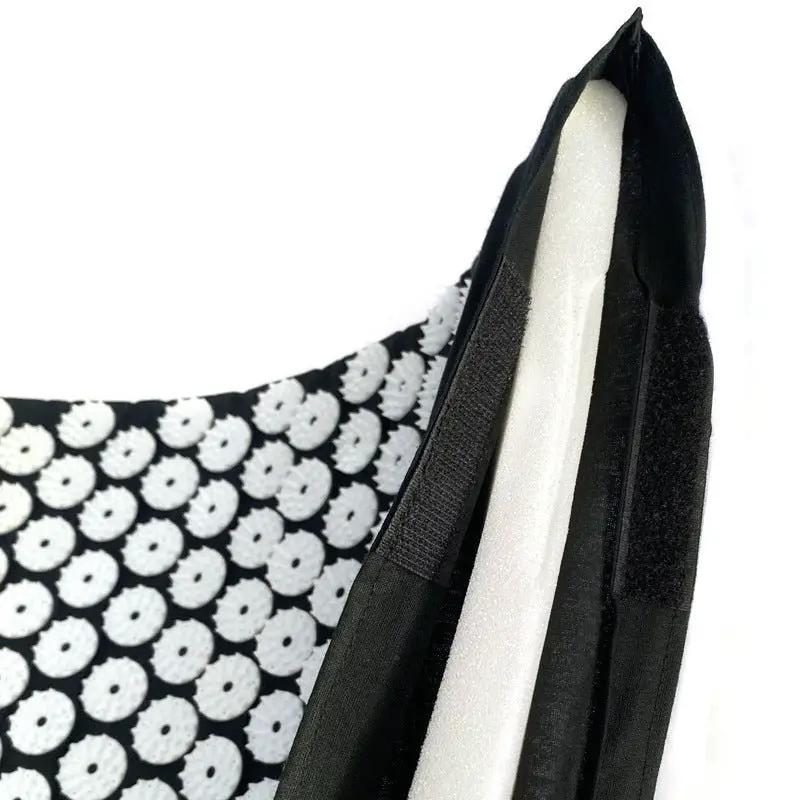 Drip Sweat Lotus Wellness Acupressure Mat with Pillow, black fabric with white lotus pattern.