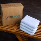Luxury Organic Bath Mats, four-pack in light blue, packaged in a cardboard box