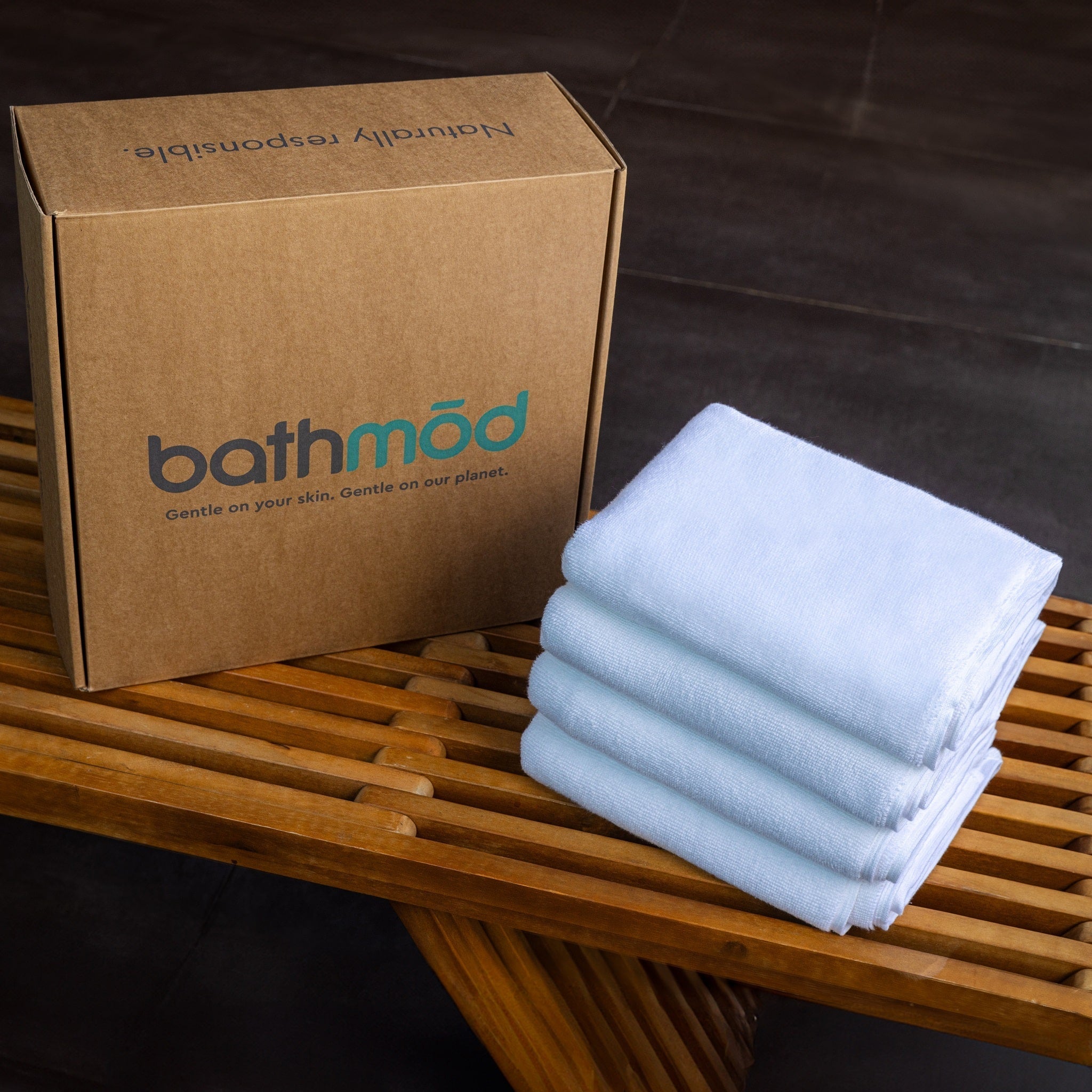 Luxury Organic Bath Mats, four-pack in light blue, packaged in a cardboard box