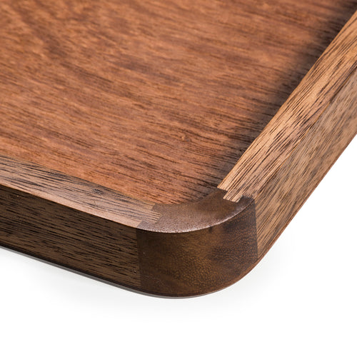 Aalborg acacia wood serving tray shown from an angle highlighting the wood grain.