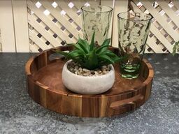 Aalborg round acacia serving tray showing wood grain.