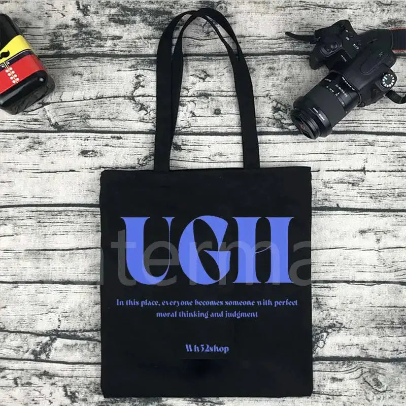 Black Kpop tote bag with blue graphic text; casual shopping tote with two black handles
