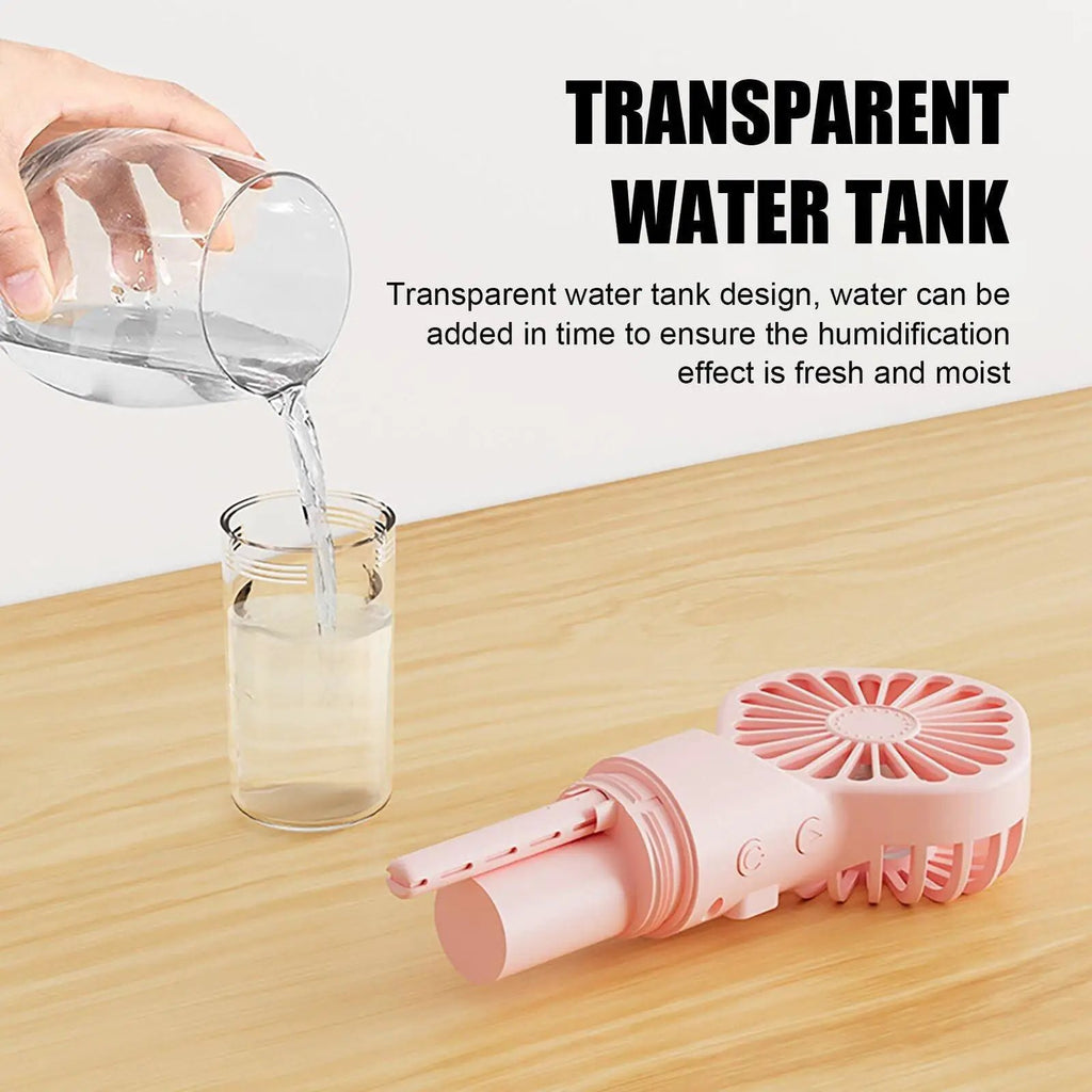 Stevvex pink portable handheld misting fan with transparent water tank, USB rechargeable.